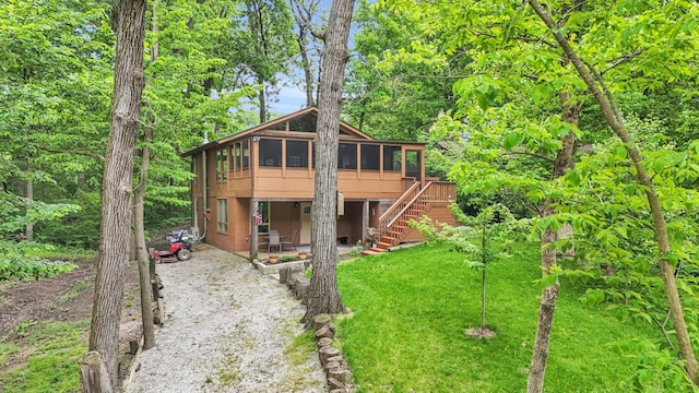 131 Shawnee Ln, Loda, IL 60948 - rustic home with a sunroom, a patio area, stairway, and a front lawn
