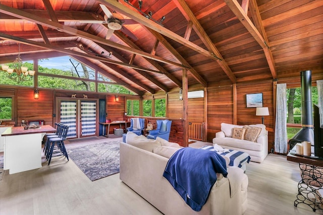 131 Shawnee Ln, Loda, IL 60948 - living room with wood ceiling, wood walls, wood finished floors, a chandelier, and a ceiling fan