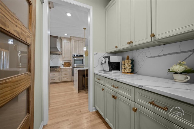 0N423 Armstrong Ln, Geneva, IL 60134 - kitchen with stainless steel appliances, wall chimney exhaust hood, light wood finished floors, tasteful backsplash, and light stone counters