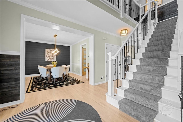 0N423 Armstrong Ln, Geneva, IL 60134 - entryway featuring stairway, wood finished floors, ornamental molding, and a chandelier