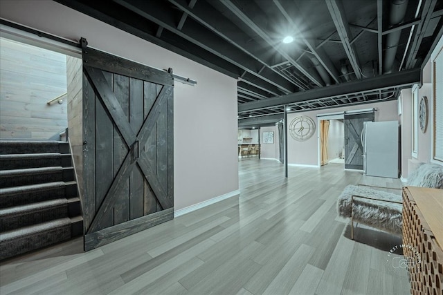 0N423 Armstrong Ln, Geneva, IL 60134 - below grade area featuring a barn door, freestanding refrigerator, stairway, and wood finished floors