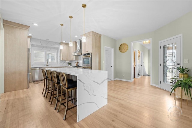 0N423 Armstrong Ln, Geneva, IL 60134 - kitchen with wall chimney exhaust hood, light wood-style floors, a center island, light stone countertops, and a kitchen breakfast bar