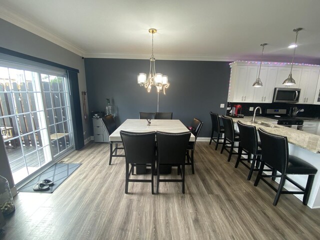 7009 W Crandall Ave, Worth, IL 60482 - dining area with light wood finished floors, a chandelier, and crown molding