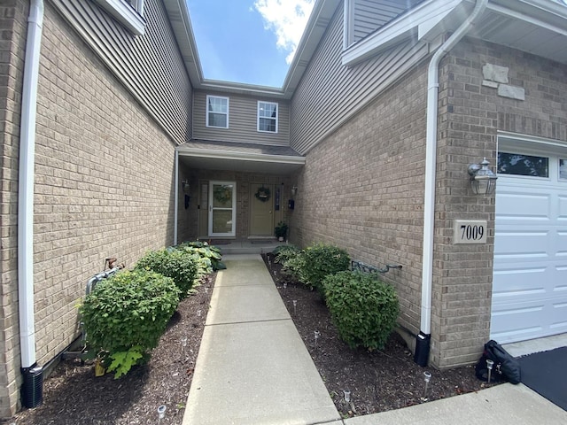 7009 W Crandall Ave, Worth, IL 60482 - doorway to property featuring brick siding and an attached garage