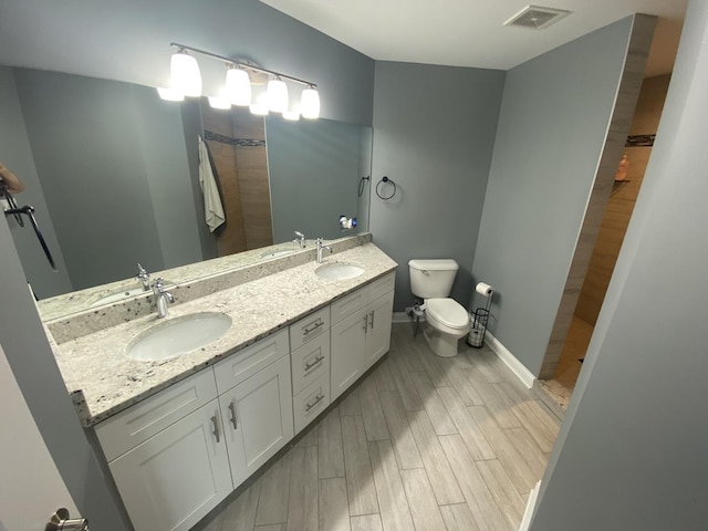 7009 W Crandall Ave, Worth, IL 60482 - bathroom featuring tiled shower, double vanity, and wood finished floors