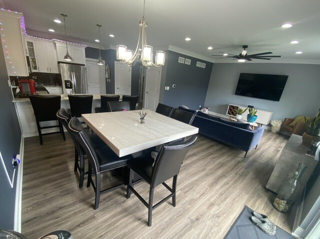 7009 W Crandall Ave, Worth, IL 60482 - dining area with crown molding, light wood-style floors, a ceiling fan, recessed lighting, and a chandelier