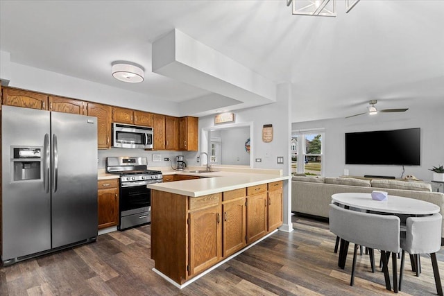 1801 Pebble Beach Cir Unit 1, Elk Grove Village, IL 60007 - kitchen with stainless steel appliances, light countertops, dark wood-style floors, and a peninsula