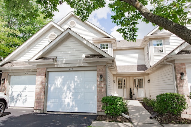 1622 Orchard Ave, Schaumburg, IL 60193 - view of front facade with an attached garage, brick siding, and asphalt driveway