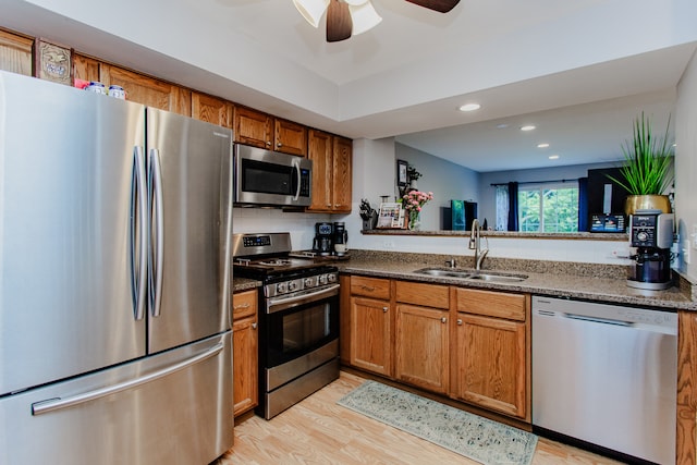 1622 Orchard Ave, Schaumburg, IL 60193 - kitchen featuring appliances with stainless steel finishes, brown cabinets, ceiling fan, light wood-style flooring, and recessed lighting