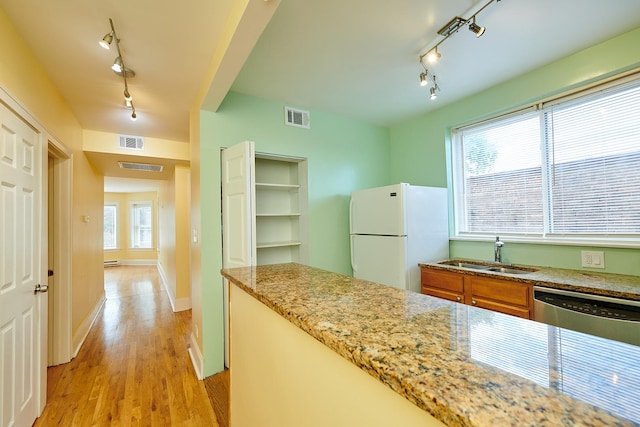 6333 N Francisco Ave Unit 2, Chicago, IL 60659 - kitchen with track lighting, freestanding refrigerator, stainless steel dishwasher, brown cabinetry, and light wood-style floors