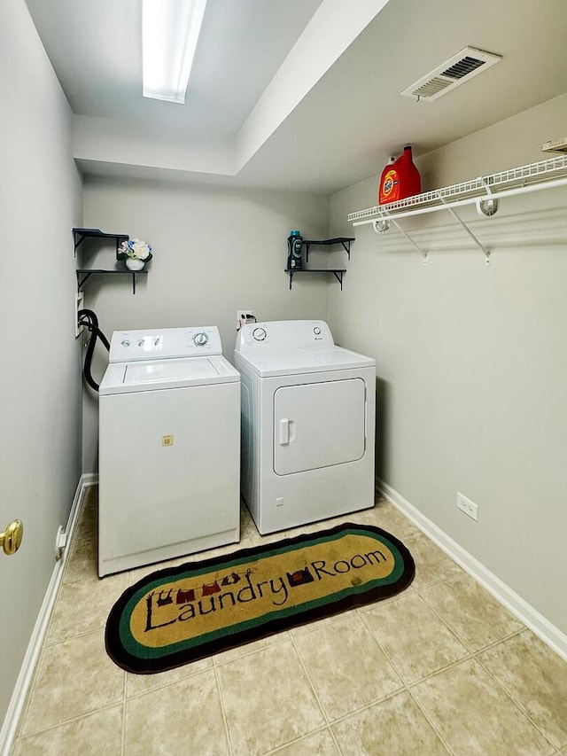 4199 Milford Ln Unit 4199, Aurora, IL 60504 - washroom featuring washing machine and clothes dryer and tile patterned floors