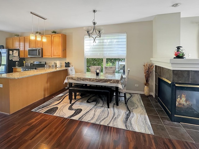 4199 Milford Ln Unit 4199, Aurora, IL 60504 - dining area with a fireplace and dark wood-type flooring