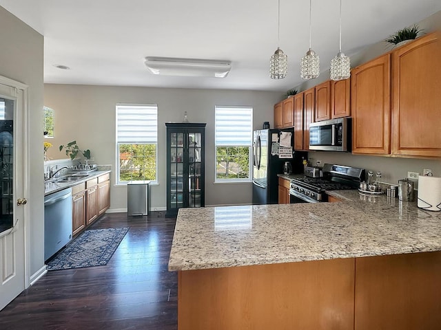 4199 Milford Ln Unit 4199, Aurora, IL 60504 - kitchen with stainless steel appliances, light stone countertops, a peninsula, dark wood-type flooring, and brown cabinetry