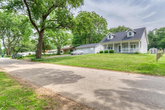 1927 Lakewood Dr, Wilmington, IL 60481 - view of front of house featuring a porch, a storage unit, a front yard, and a shingled roof