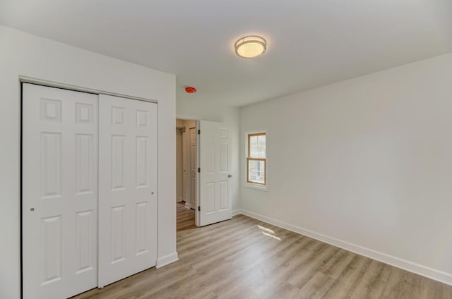 1927 Lakewood Dr, Wilmington, IL 60481 - unfurnished bedroom with light wood-style floors and a closet