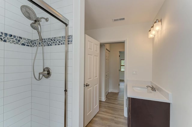 1927 Lakewood Dr, Wilmington, IL 60481 - bathroom with a stall shower, vanity, and wood finished floors