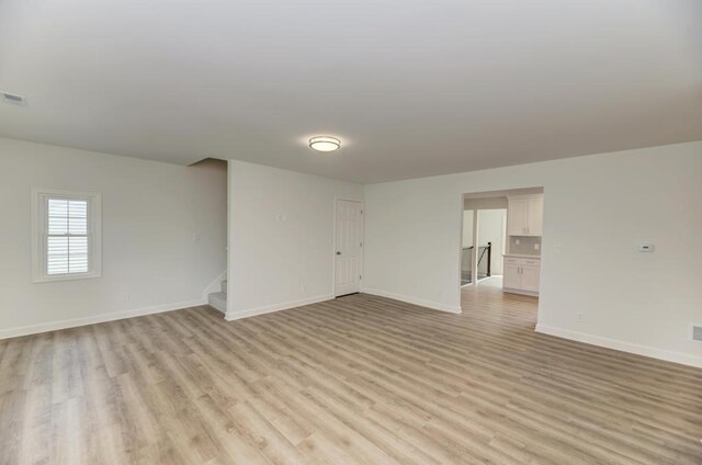 1927 Lakewood Dr, Wilmington, IL 60481 - empty room with light wood-style floors and stairs