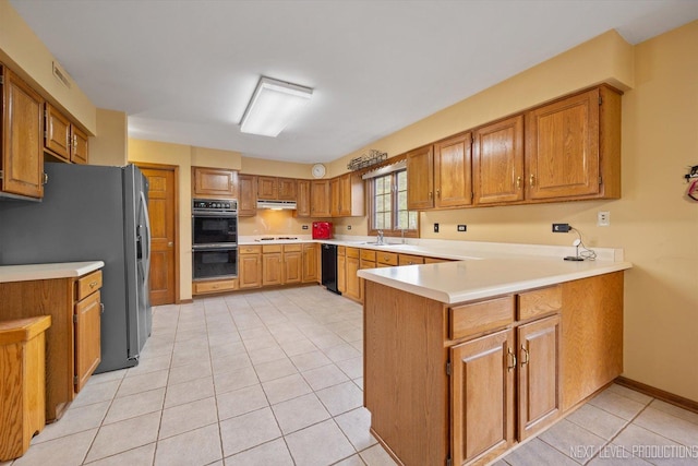 3609 Tamarisk Ct, Crystal Lake, IL 60012 - kitchen featuring black appliances, a peninsula, light tile patterned flooring, light countertops, and brown cabinets