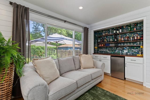 1923 Warren St, Evanston, IL 60202 - living room featuring bar with sink, light wood finished floors, healthy amount of natural light, crown molding, and recessed lighting