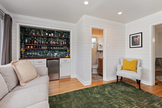 1923 Warren St, Evanston, IL 60202 - indoor dry bar featuring fridge, light wood-style flooring, ornamental molding, wood walls, and recessed lighting
