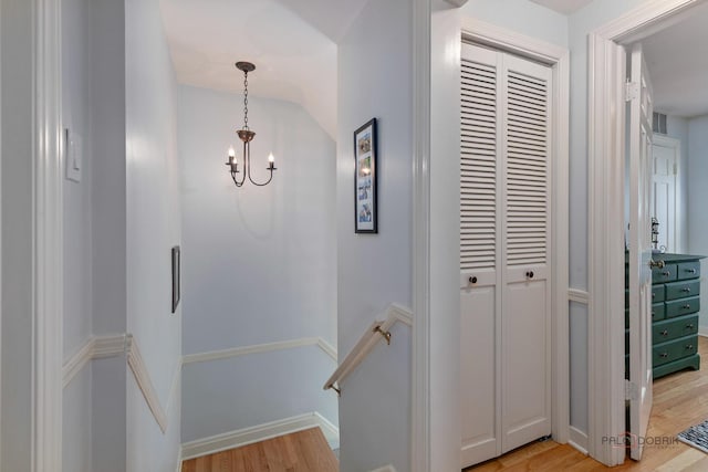 1923 Warren St, Evanston, IL 60202 - hallway featuring light wood-type flooring, an upstairs landing, and a chandelier