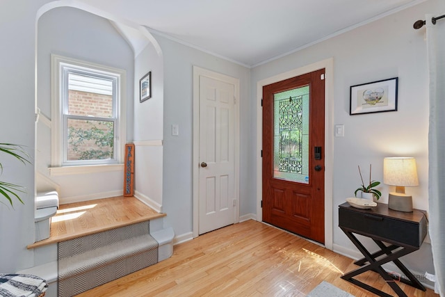 1923 Warren St, Evanston, IL 60202 - entrance foyer featuring light wood-style flooring, arched walkways, and crown molding