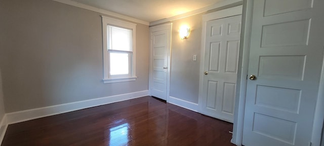 1325 21st Ave, Rockford, IL 61104 - unfurnished bedroom with dark wood-style flooring and baseboards