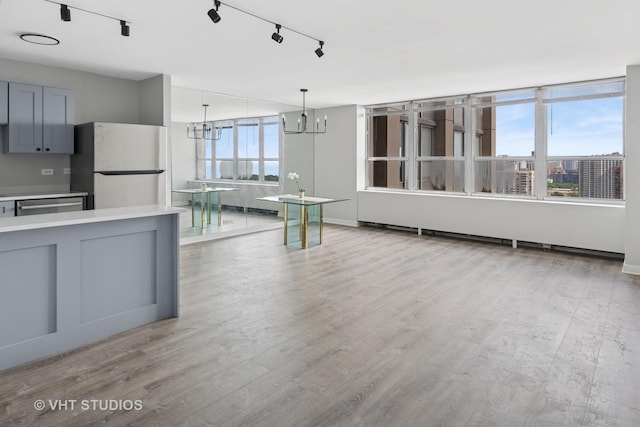 655 W Irving Park Rd Unit 2608, Chicago, IL 60613 - kitchen featuring freestanding refrigerator, a chandelier, gray cabinets, light countertops, and light wood-style flooring