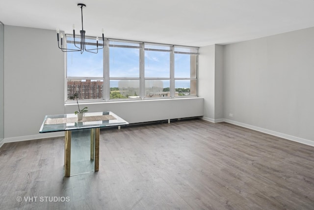 655 W Irving Park Rd Unit 2608, Chicago, IL 60613 - unfurnished dining area featuring wood finished floors and a chandelier