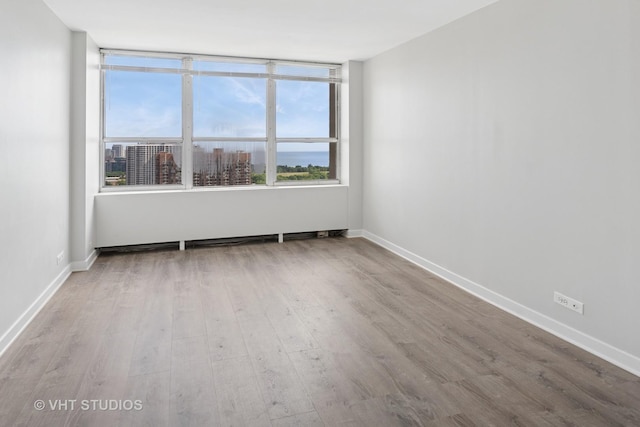 655 W Irving Park Rd Unit 2608, Chicago, IL 60613 - spare room featuring wood finished floors and baseboards
