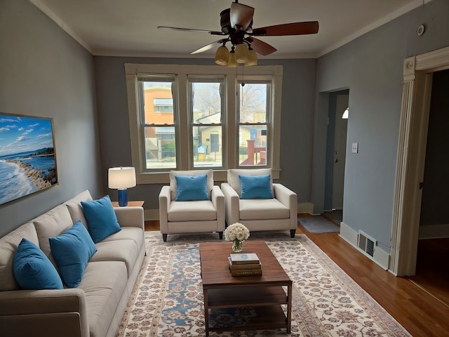 7417 S Saint Lawrence Ave, Chicago, IL 60619 - living area featuring ceiling fan, wood finished floors, and crown molding