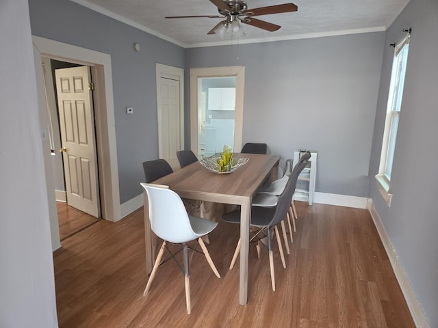 7417 S Saint Lawrence Ave, Chicago, IL 60619 - dining room featuring wood finished floors, ceiling fan, and crown molding