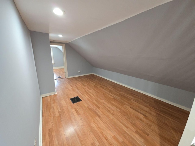 7417 S Saint Lawrence Ave, Chicago, IL 60619 - additional living space with vaulted ceiling, light wood-style floors, and recessed lighting