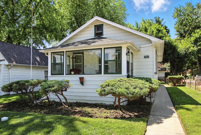 907 W Grove Ave, Waukegan, IL 60085 - bungalow-style house with a sunroom and a shingled roof