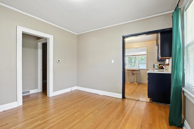 907 W Grove Ave, Waukegan, IL 60085 - spare room with light wood finished floors and ornamental molding