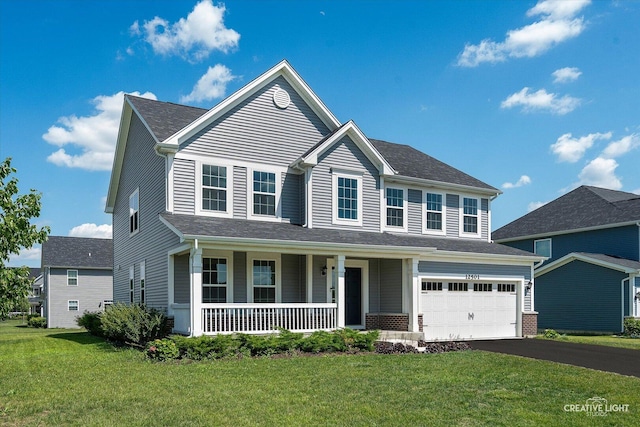 12501 S Willowgate Ln, Plainfield, IL 60585 - view of front facade featuring a porch, asphalt driveway, a front lawn, and a garage