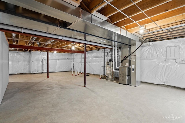 12501 S Willowgate Ln, Plainfield, IL 60585 - unfinished below grade area with gas water heater, heating unit, and electric panel