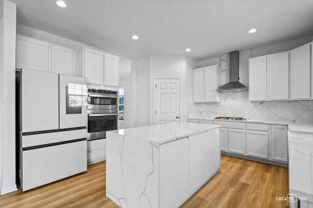 12501 S Willowgate Ln, Plainfield, IL 60585 - kitchen featuring wall chimney exhaust hood, double oven, freestanding refrigerator, recessed lighting, and light wood-type flooring