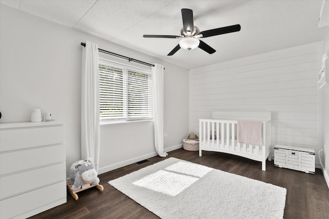 7020 Heritage Cir Unit 6-1D, Orland Park, IL 60462 - bedroom with wood finished floors, a nursery area, and a ceiling fan