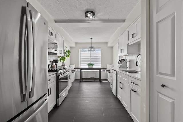 7020 Heritage Cir Unit 6-1D, Orland Park, IL 60462 - kitchen featuring appliances with stainless steel finishes, white cabinets, light countertops, decorative backsplash, and decorative light fixtures