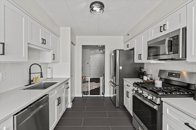 7020 Heritage Cir Unit 6-1D, Orland Park, IL 60462 - kitchen featuring appliances with stainless steel finishes, white cabinetry, light countertops, and a textured ceiling