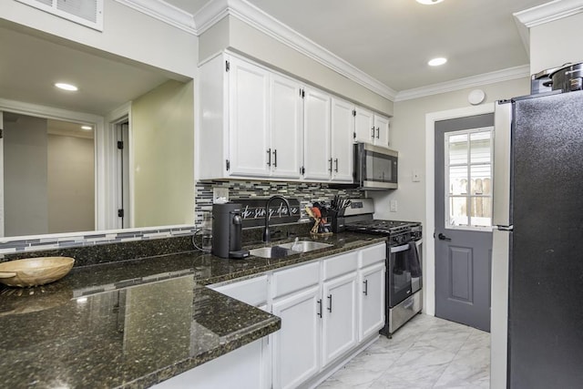 38515 N Forest Ave, Spring Grove, IL 60081 - kitchen featuring appliances with stainless steel finishes, white cabinets, light marble finish floors, tasteful backsplash, and crown molding