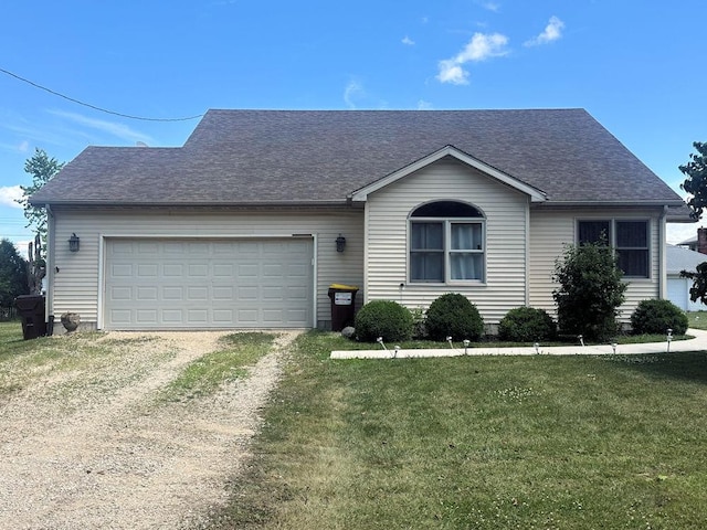 314 N Grove St, Rochelle, IL 61068 - view of front of property with dirt driveway, a front yard, an attached garage, and a shingled roof