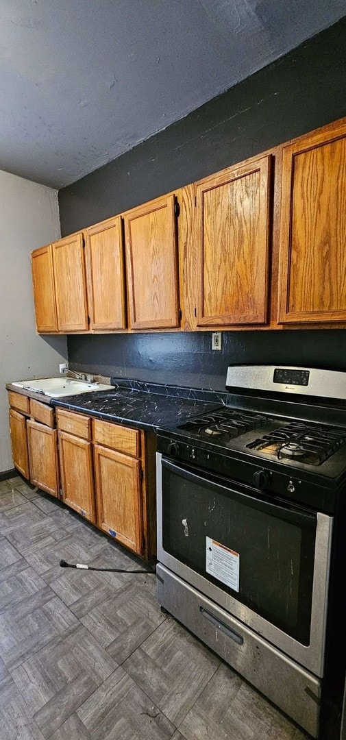 7934 S Saginaw Ave, Chicago, IL 60617 - kitchen featuring stainless steel gas range oven and dark countertops