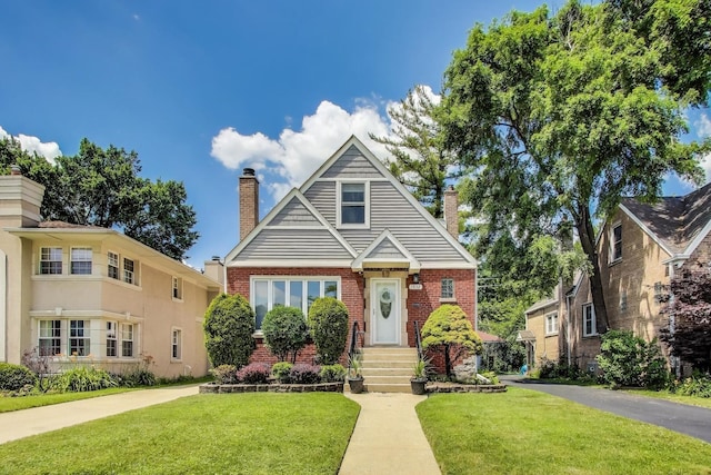 1832 N 73rd Ct, Elmwood Park, IL 60707 - bungalow-style house featuring a chimney, brick siding, and a front lawn