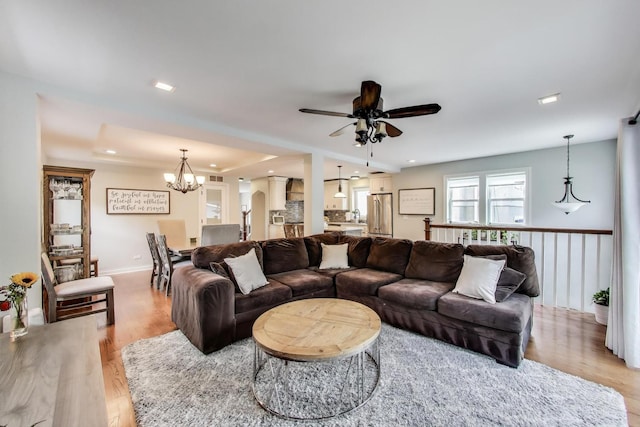 1832 N 73rd Ct, Elmwood Park, IL 60707 - living area featuring a chandelier, a ceiling fan, light wood-style floors, a raised ceiling, and recessed lighting