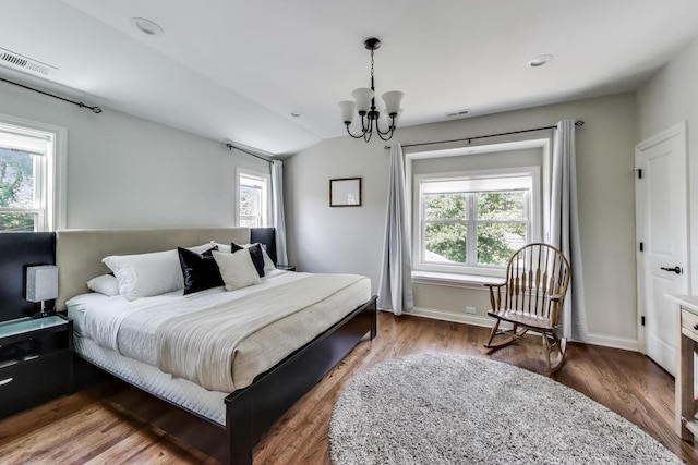 1832 N 73rd Ct, Elmwood Park, IL 60707 - bedroom with multiple windows, a chandelier, vaulted ceiling, and wood finished floors