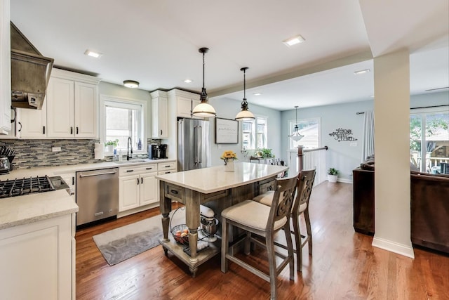 1832 N 73rd Ct, Elmwood Park, IL 60707 - kitchen with stainless steel appliances, custom range hood, healthy amount of natural light, and recessed lighting