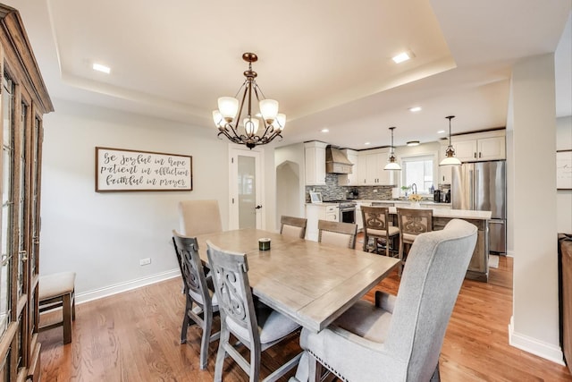 1832 N 73rd Ct, Elmwood Park, IL 60707 - dining space featuring a tray ceiling, a chandelier, light wood-style flooring, and recessed lighting
