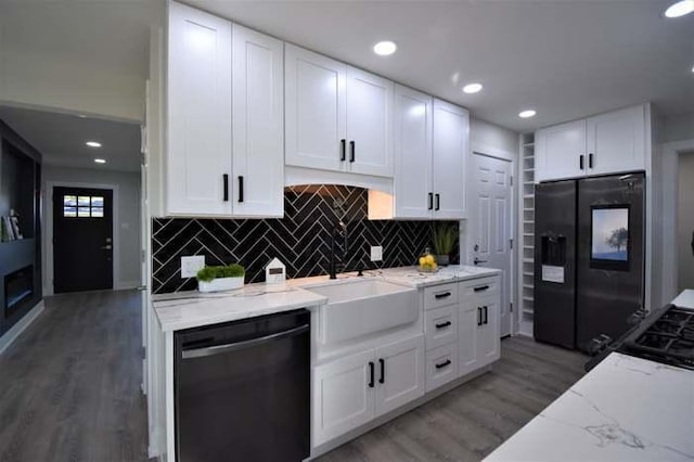 700 Delphia Ave, Elk Grove Village, IL 60007 - kitchen with dishwasher, black refrigerator with ice dispenser, light stone countertops, light wood-type flooring, and tasteful backsplash
